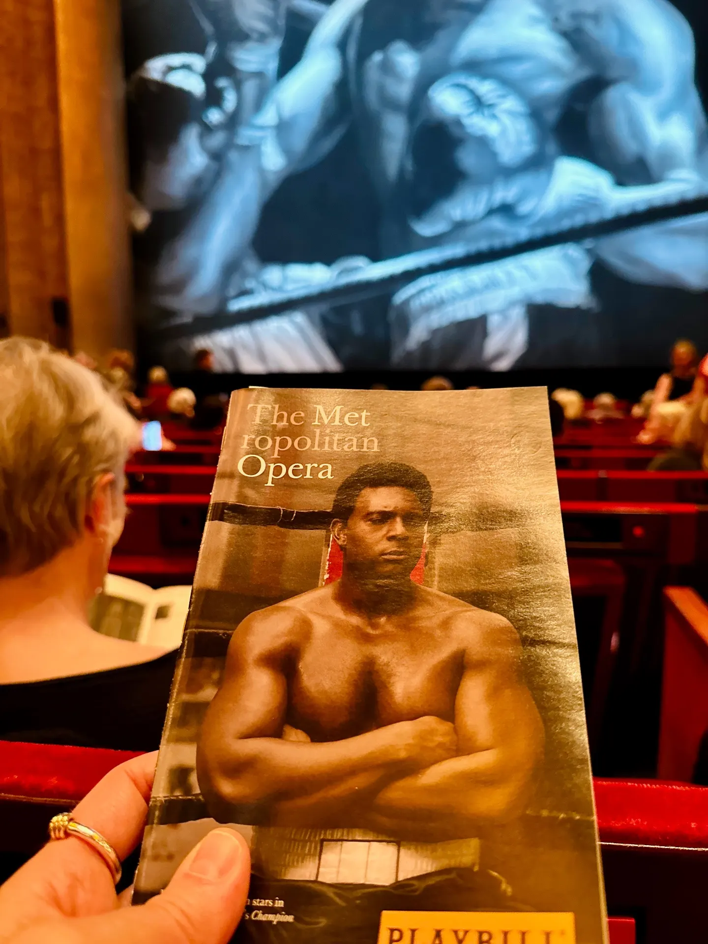 Metropolitan Opera Playbill for Terence Blanchard's Champion held up before the act-drop, a boxer painted in blue above