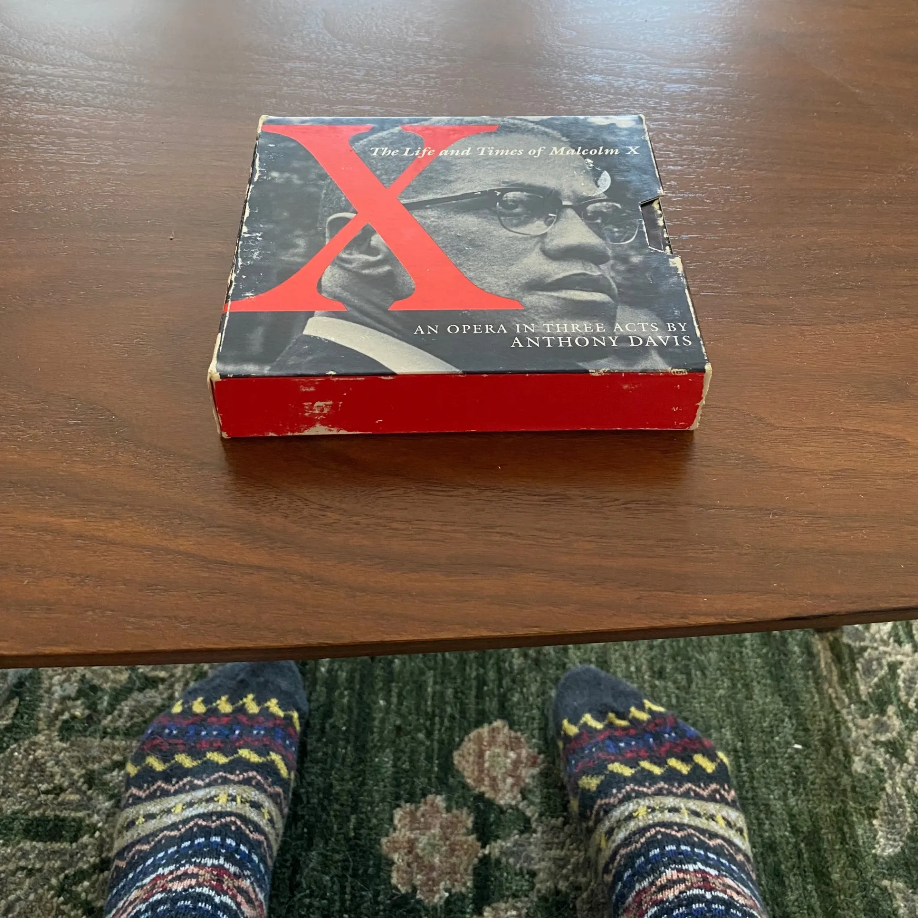 Boxed set of X: The Life and Times of Malcolm X by Anthony Davis on a wooden table