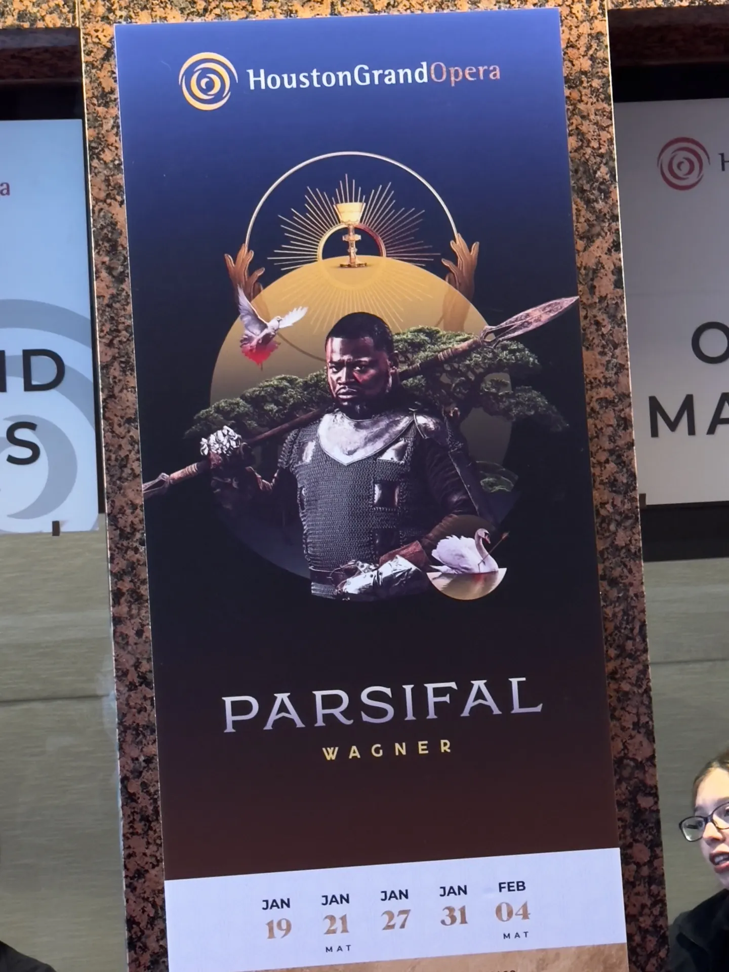 Houston Grand Opera Parsifal lobby poster — Russell Thomas as Parsifal in chainmail holding a spear, gold Grail halo behind, run dates January 19–February 4