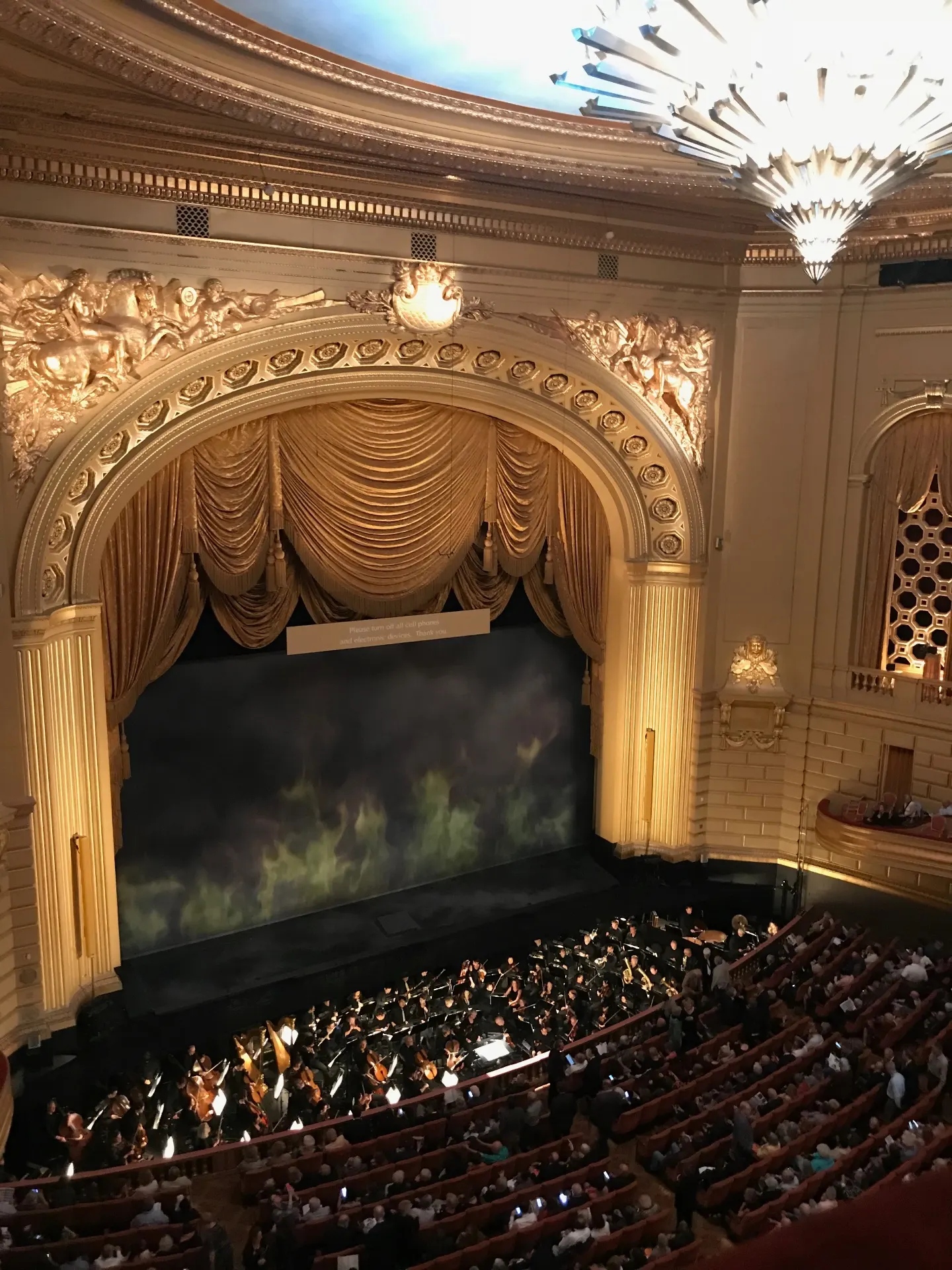 Gilded proscenium and chandelier of the War Memorial Opera House before curtain